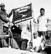 Dave Smith in Spain with a banner Tom Mooney Machinegun Company