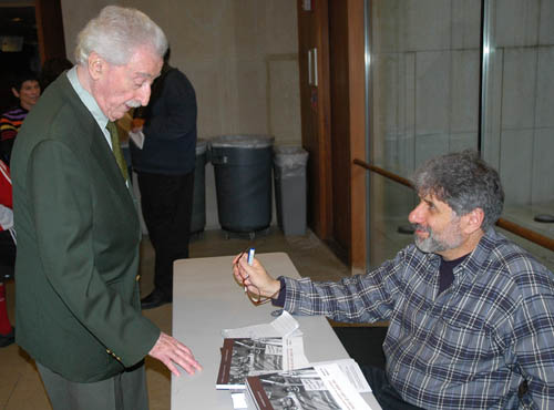 Moe Fishman talking with Richard Bermack who is signing books