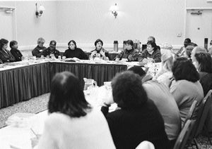 Dion Aroner meeting with the committee around several tables. She is speaking and workers are listening.