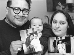 Jacob Ocampo, with Maya and her new born baby. Jacob and Maya are holding up photos of him  standing next to Maya,who is wearing a graduation gound, and seated in a wheel chair. Ocampo is wearing a suit and tie in the photo he is holding up. 