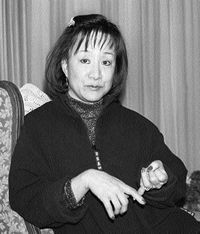 Nusre sitting in a chair talking