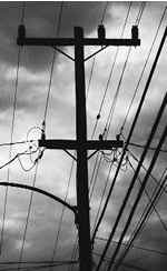 ominus powerlines with storm clouds in the background