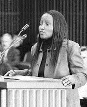 Sonya Henry speaking at a microphone.