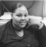 Trinity Wallaec sittling at a desk looking throughtful