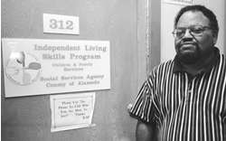 Leonard  Moncure by the Independent Living Skills Program sign