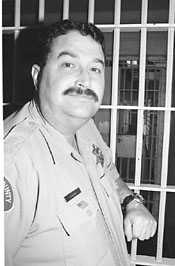 Victor McGill leaning on a jail cell door