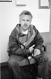 Gary Angel sitting down, he needs a cane to walk.