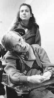 Diana Temkin pushing Peter in a wheel chair