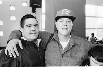 Tyler with a her arm around a client