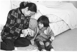 Social worker Cheng playing with a young child