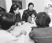 family sitting around the table with social workers