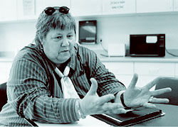 Female social worker at desk jesturing preplexed