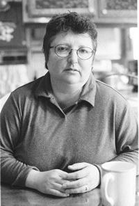 Portraint of Maryellen sitting at a table wiht a coffee cup