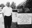 Brian Harris standing next to a sign for Solono County Metal Health 