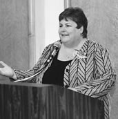 Janet Atkins jesturing while speaking at podium