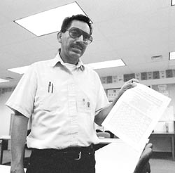 Carlos Campos holding up a set of documents