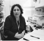 Nora in her office with paper work around her