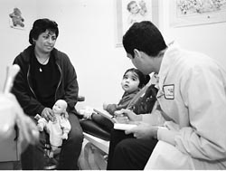 La Clinica de La Raza Dr. Negron  teaches Mousella how to brush her teeth