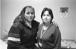 Nurse assistant Yanetha Olivia standing next to patient Mria Barahs 