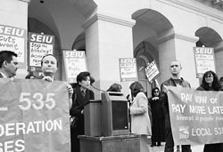 Assembly woman Judy Chu speaking at a rally with local 535 banners