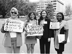 Students with picket signs protesting cuts in Medical