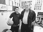 Student Jason with a basket ball standing next to Jose Moreno