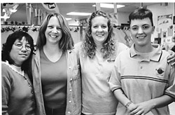 four workers with arms around each other