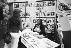 Social worker sitting at a table talking with a parent.