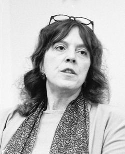 Marylin Senf, wearing a scar and looking pensive