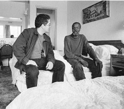 Matt sitting next to James in side his motel room.