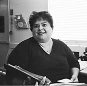 Jessica holding some papers and smilling