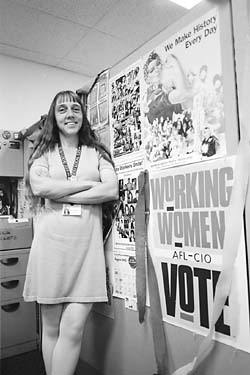 Matti Parfitt standing by  a poster -Working Women