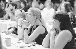 workers listening to a speaker at a meeting