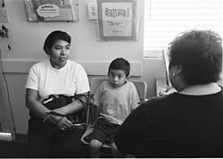 Mother and child being interviewed by head start worker