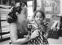 Head start worker attending to young girl