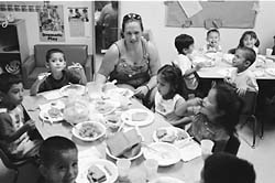 Teacher Stacy Van Note helping children making peanut butter sandwiches