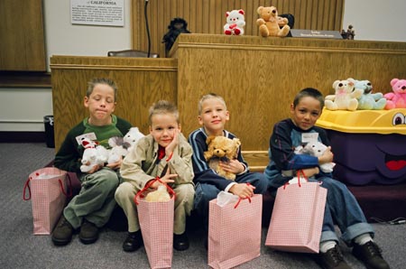 Four brothers with stuffed animals