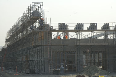 bricklayers working on a multi story office building