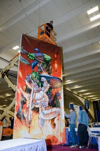 Sign and display worker hanging a banner from a lift 20 feet high