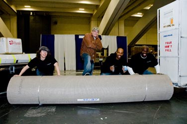 Sign and display workers rolling out a carpet
